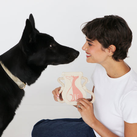 Black German Shepherd dog with woman holding Gemini dog toy