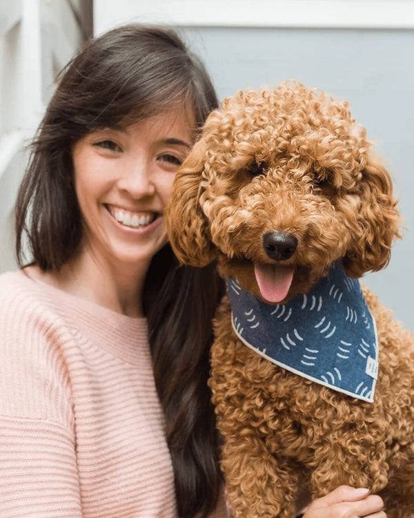 Woman with brown hair with poodle dog wearing bandana